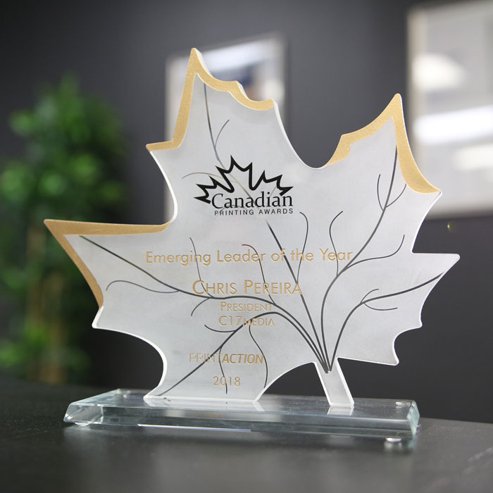 Award for Emerging Leader of the Year presented to Chris Pereira, President of C17media, at the Canadian Printing Awards, 2018, displayed on a decorative maple leaf-shaped trophy.