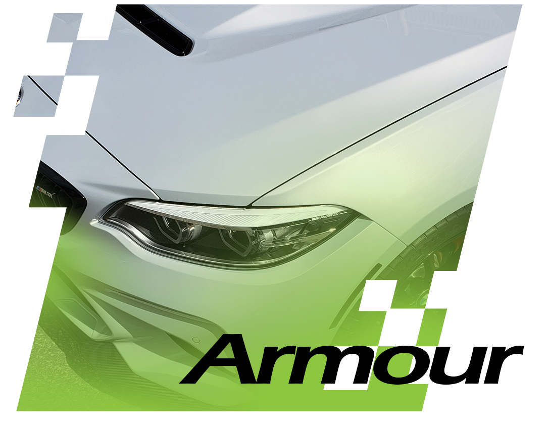 Close-up of a sleek, modern vehicle showcasing its front design and headlight features, with the word "Armour" prominently displayed, emphasizing automotive protection and styling solutions by C17Auto Armour.